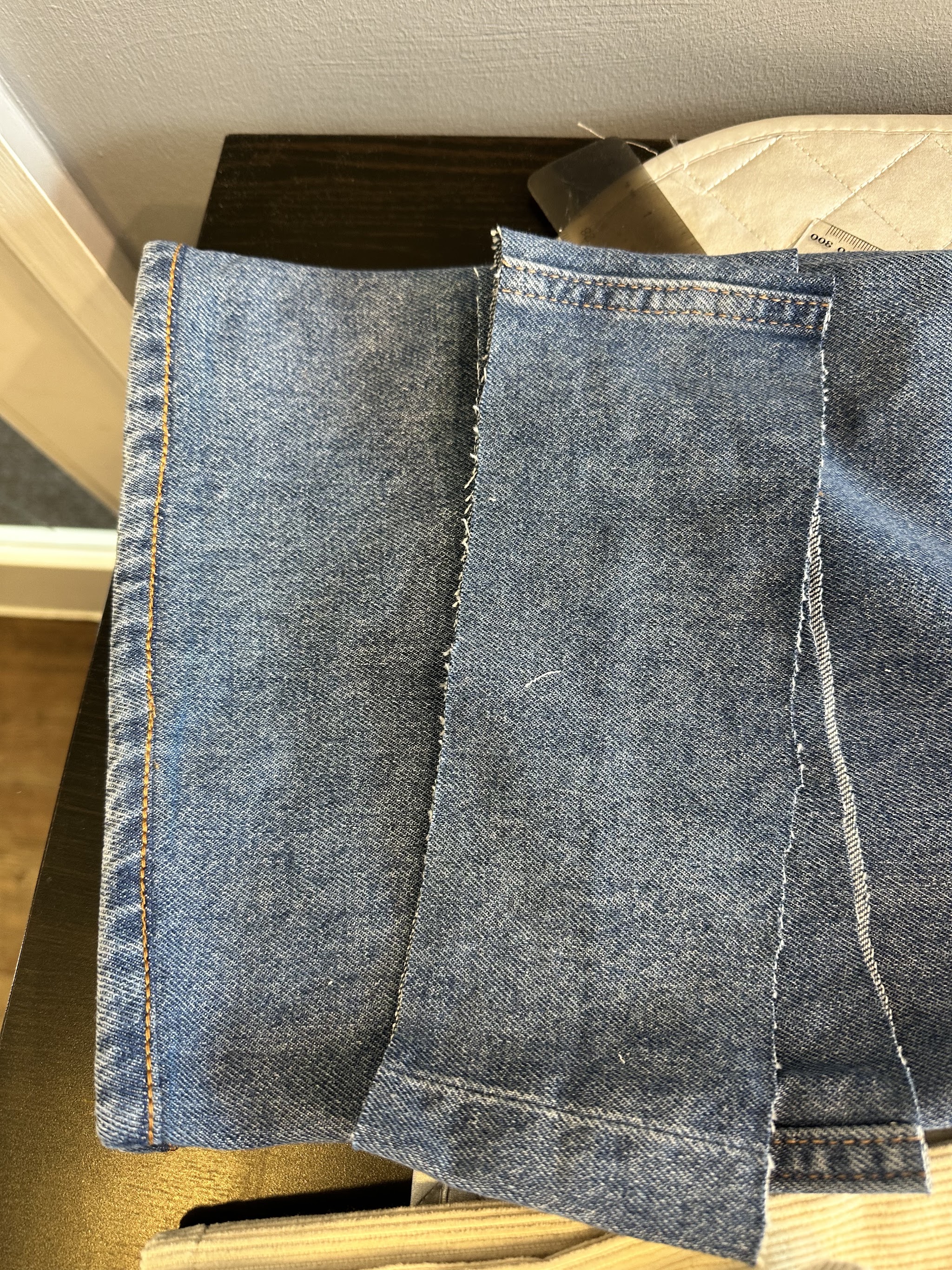 Close view of denim hems and stitching